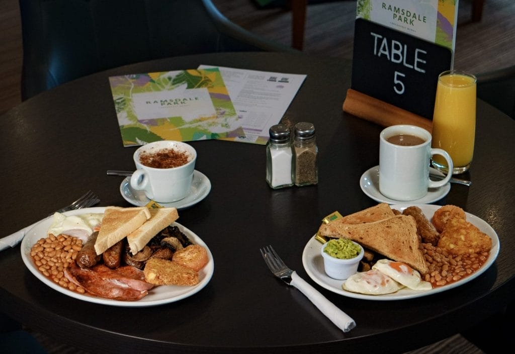 Full English breakfast with tea, coffee, and juice at restaurant in Calverton