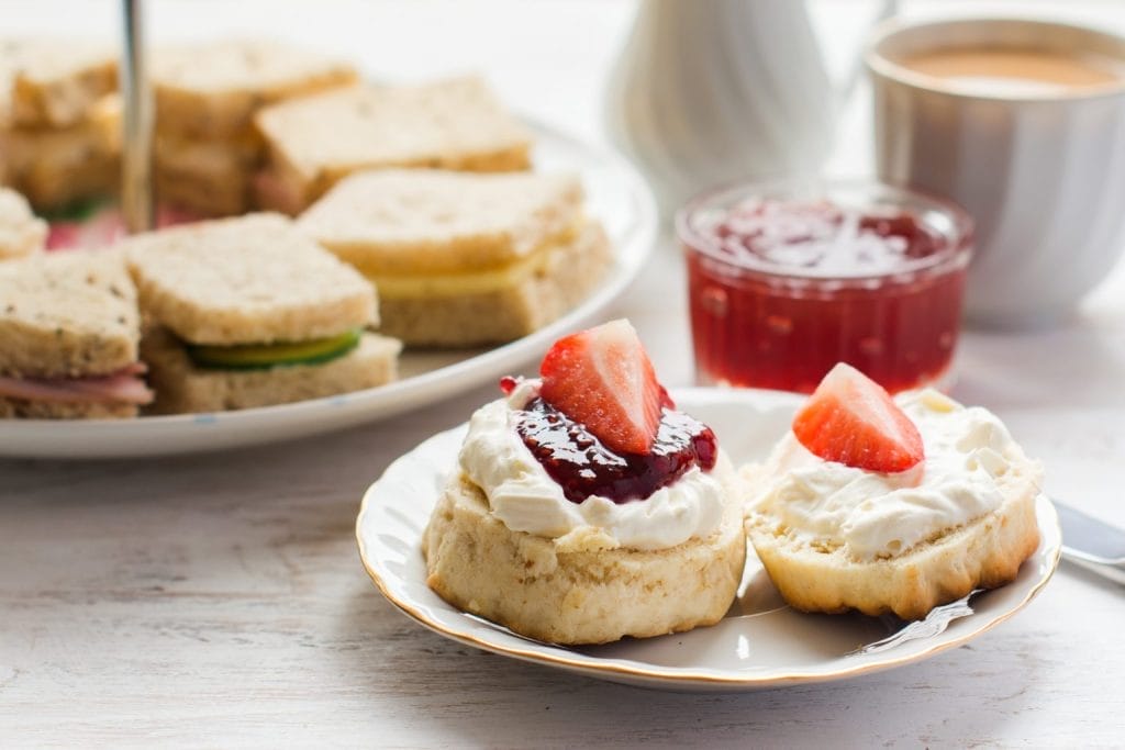 Afternoon tea with scones with tea and sandwiches served at restaurant in Nottingham