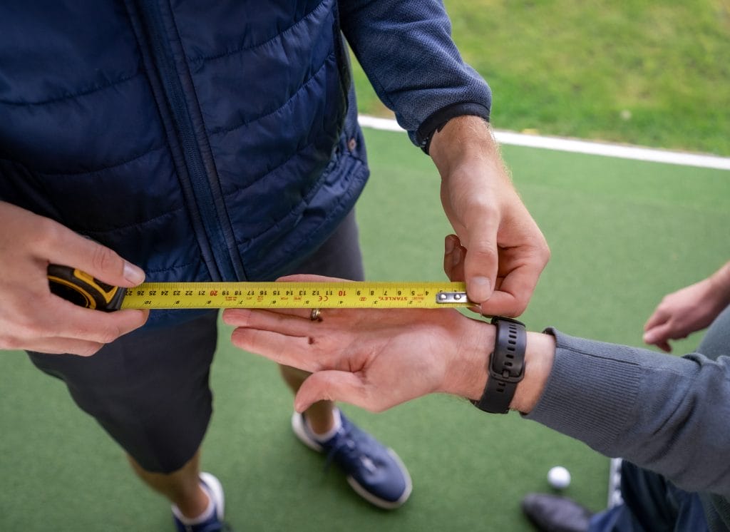 golfers hand getting measured during a custom fitting session near nottingham