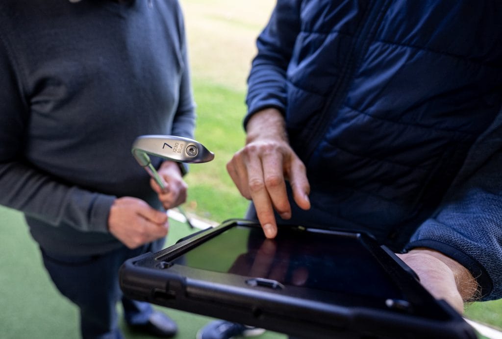 golfer getting swing advice during a golf lesson in nottingham