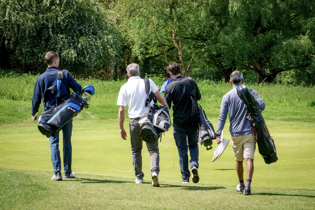 men walking together during a round of group golf in nottingham