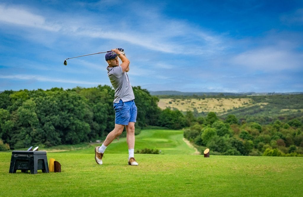 Golfer teeing at a course in nottingham with scenic views at Ramsdale Park