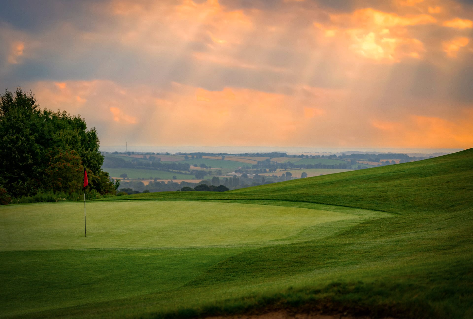 sun setting over the green at a golf club near nottingham