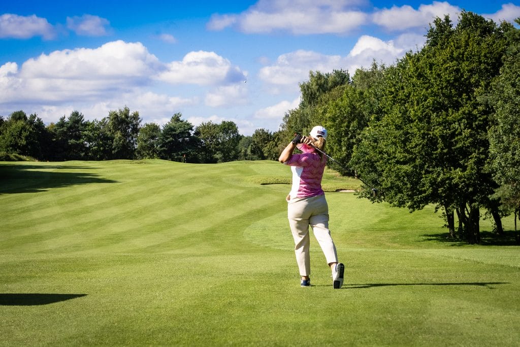 women Golfer hitting a shot into the fairway at a golf club in nottingham