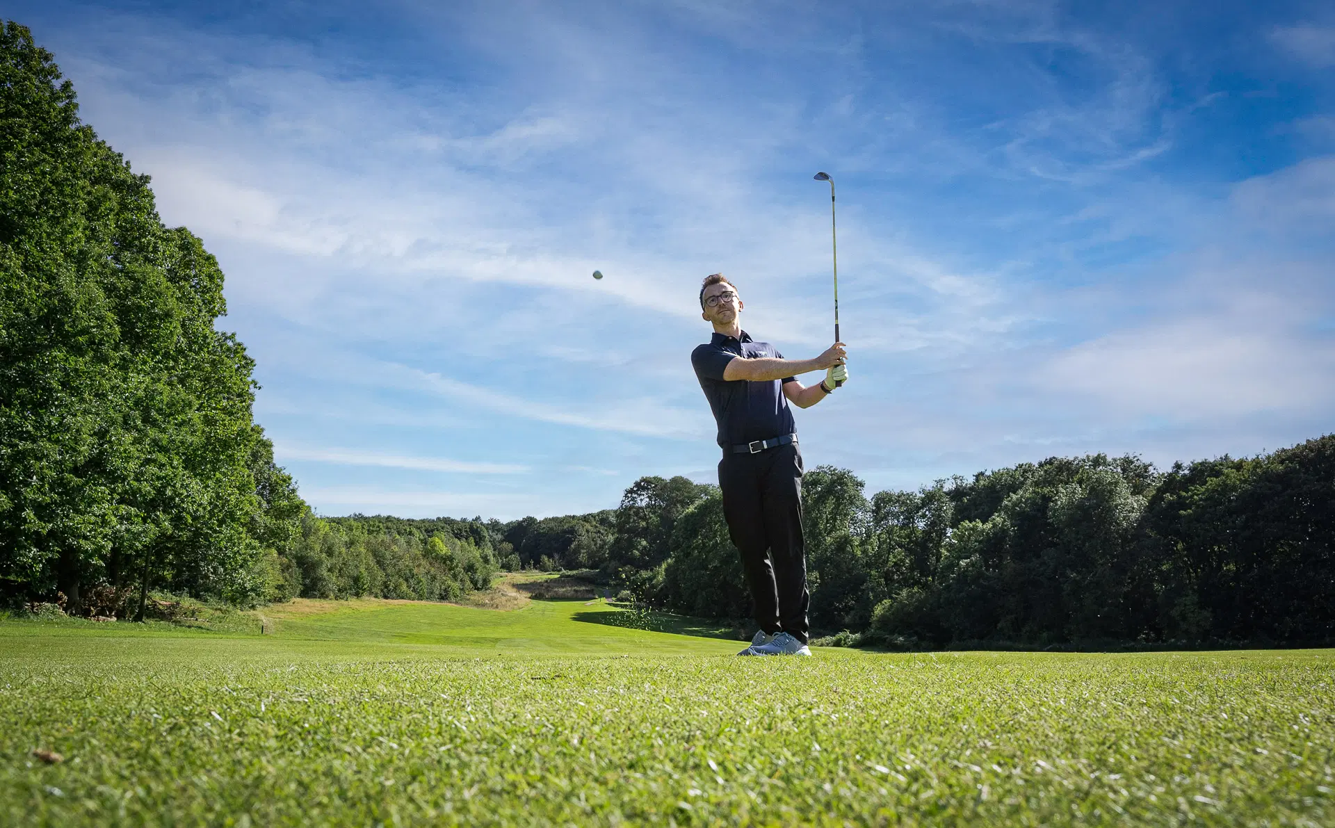 man hitting golf ball at a golf course in nottingham