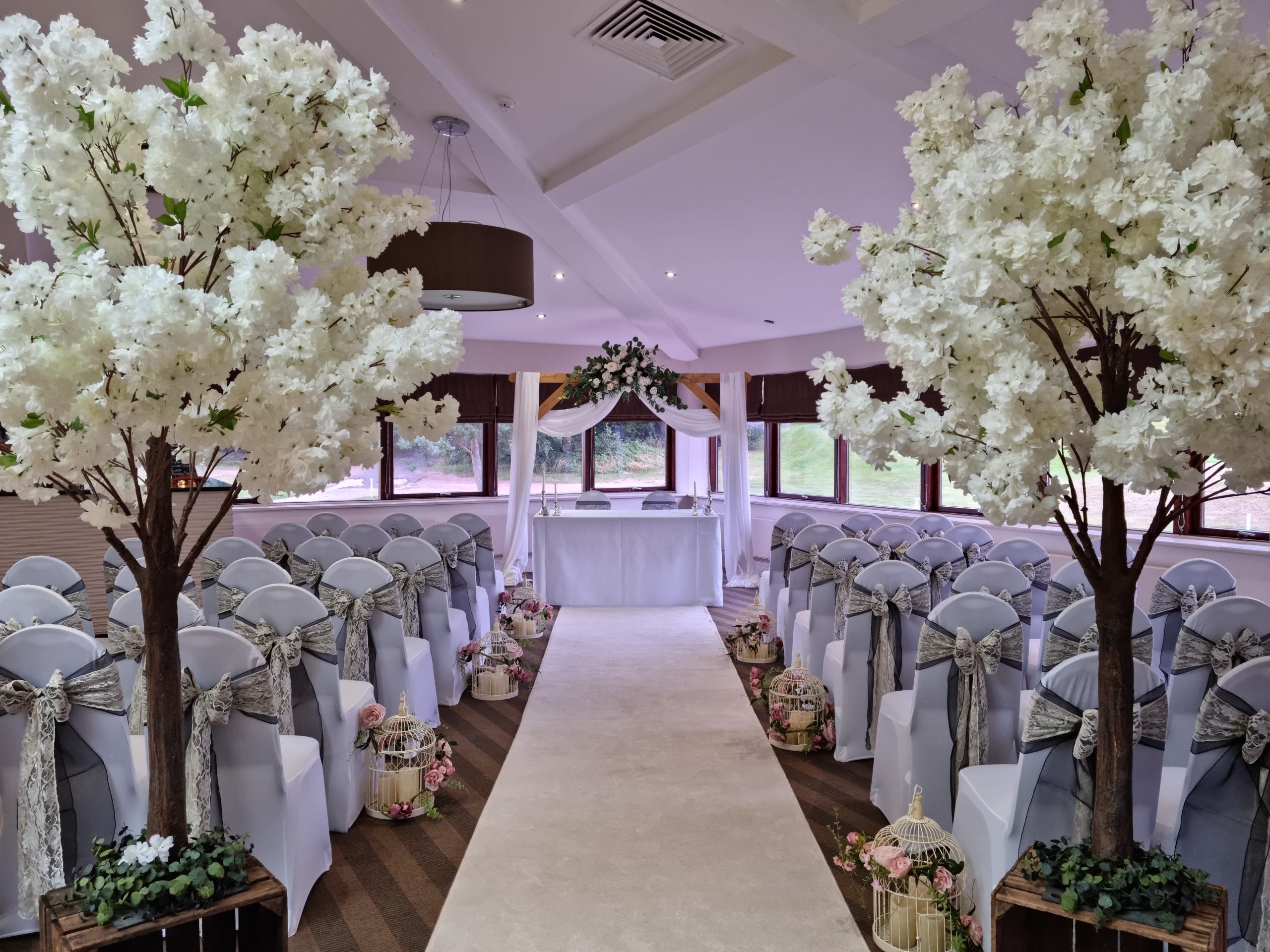 wedding aisle in nottingham decorated with white trees and flowers