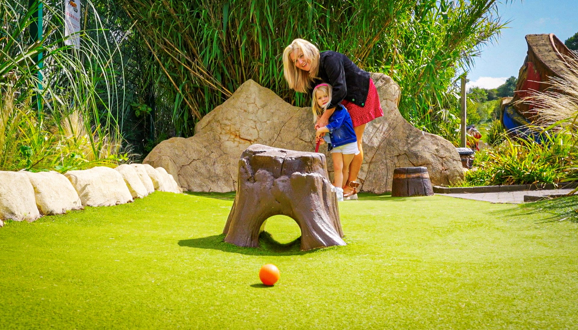 Mother and daughter playing crazy golf