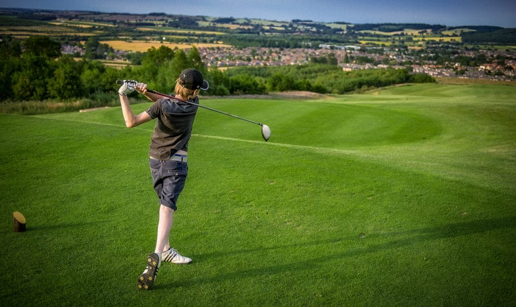 junior golfer hitting his driver at an 18 hole golf course in nottingham