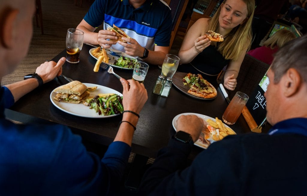 young people sat enjoying food at a restaurant near nottingham