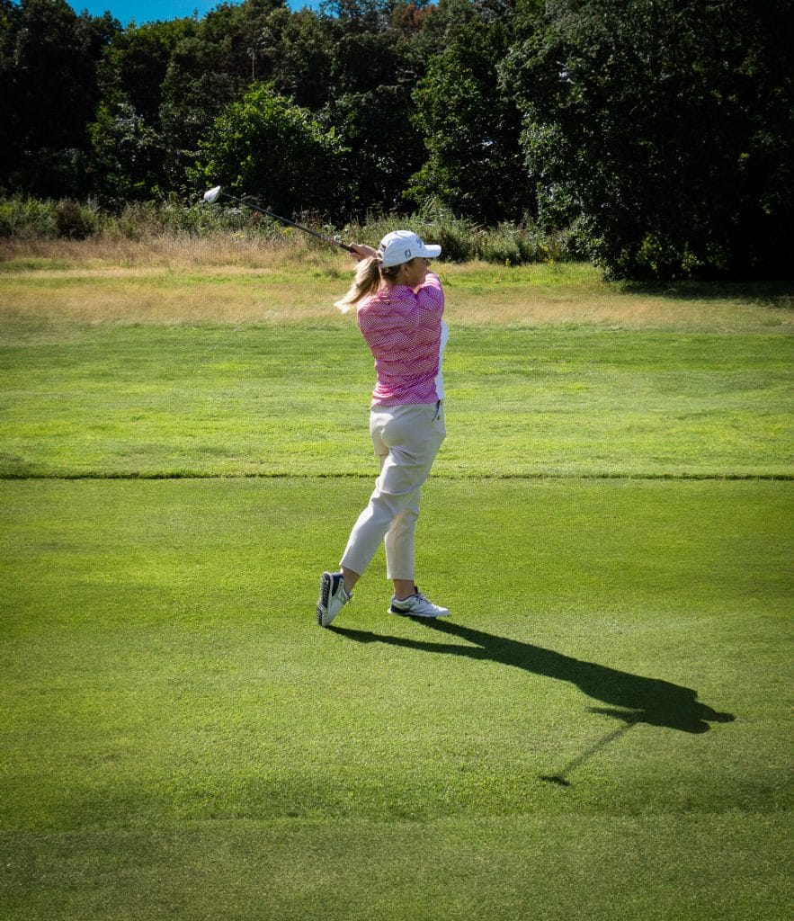 women hitting a golf ball at a golf course in nottingham