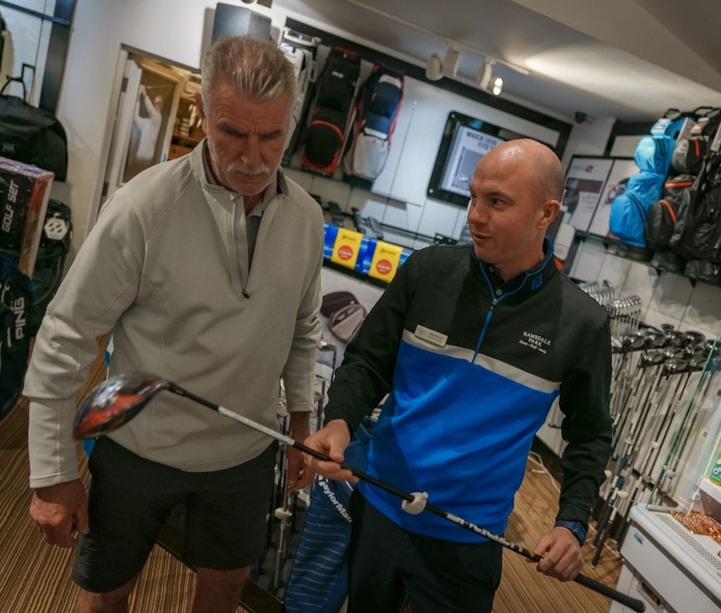 golf professional talking about golf club in a golf golf shop in nottingham
