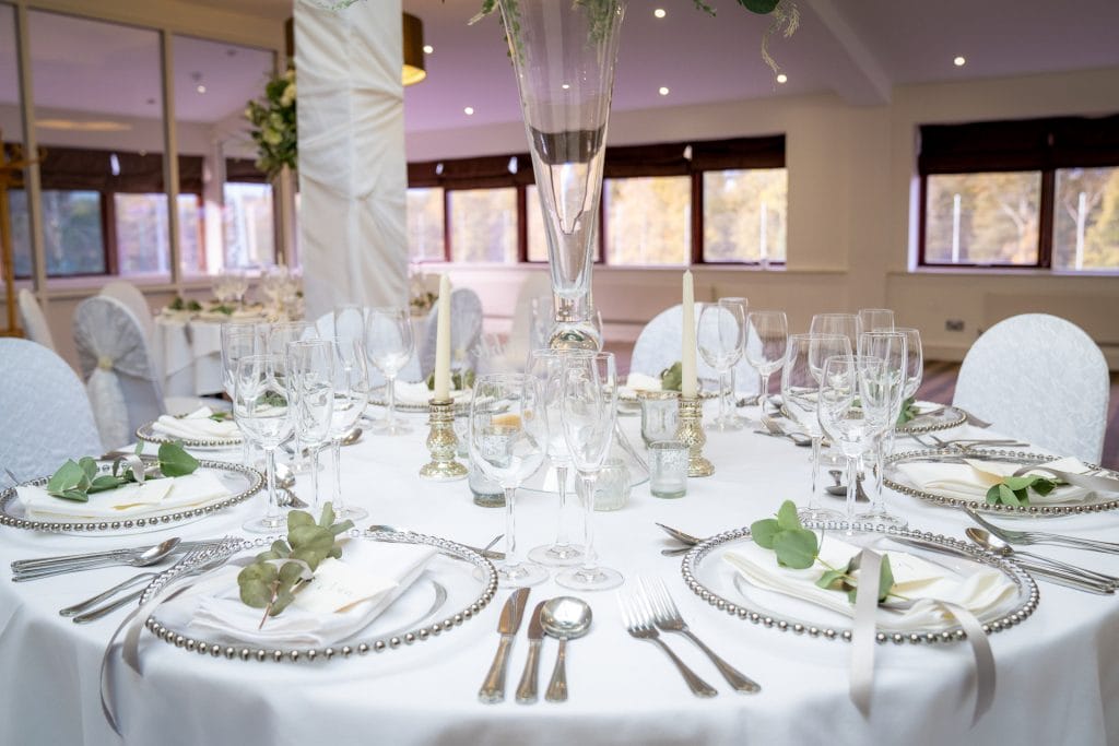 wedding table arranged with flowers, silver croquery and candles for a wedding near nottingham