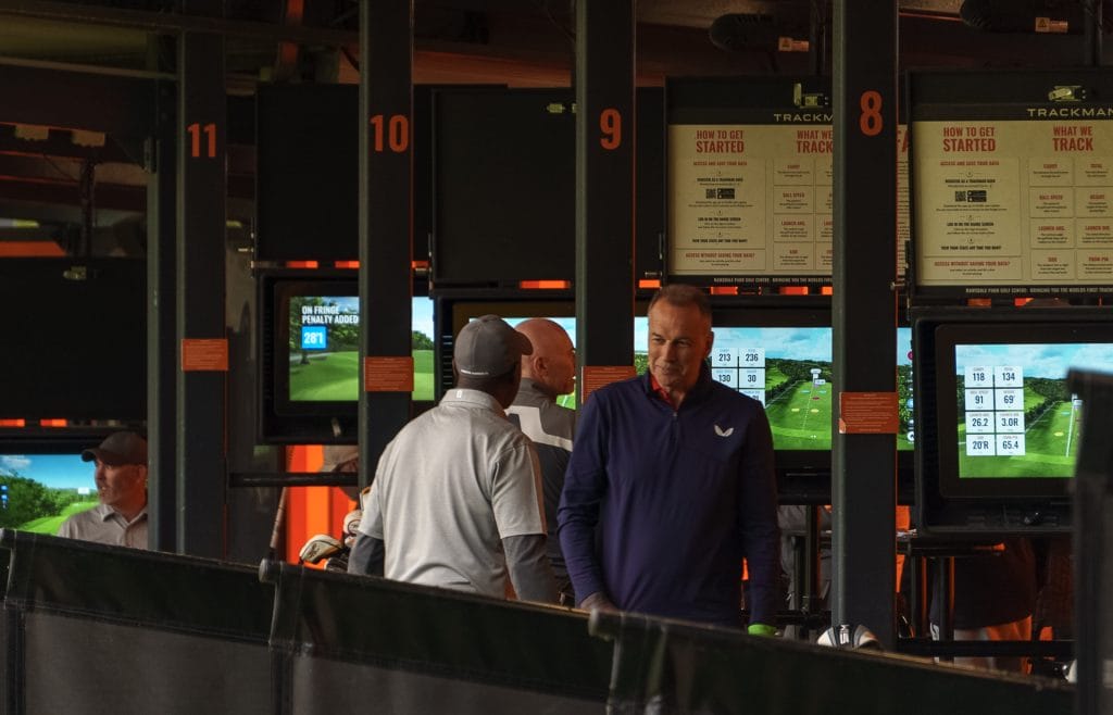 two golfers playing golf at a driving range in nottinghamshire