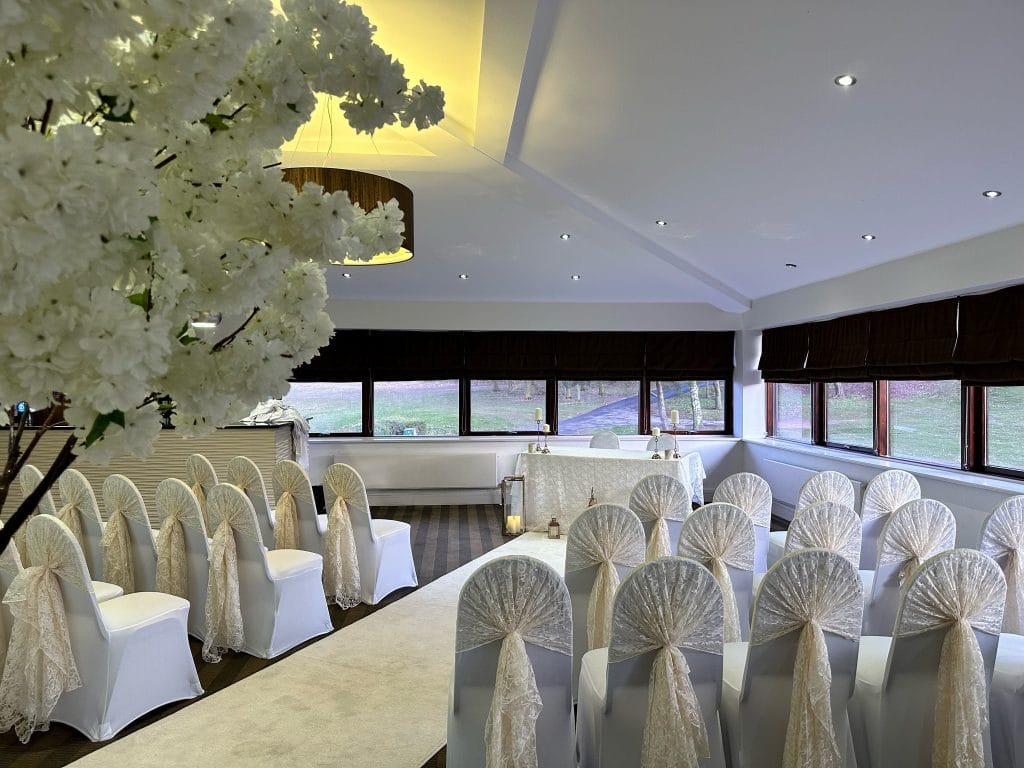 wedding aisle with trees and white chair sashes in nottingham