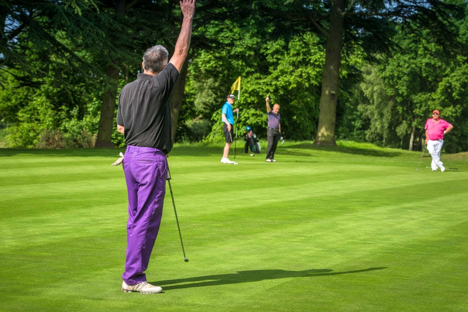 Group of golfers celebrating on green after a group golf day in nottingham